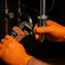 plumber making a repair while wearing disposable orange nitrile gloves by copperhead