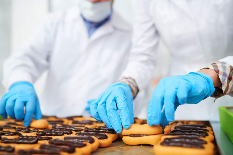 Blue Nitrile Disposable Gloves Being Used in Food Manufacturing