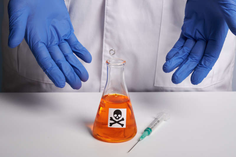 man wearing nitrile gloves handling chemicals